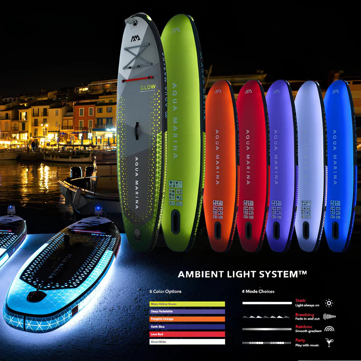 Colorful Aqua Marina Glow inflatable stand-up paddle boards with ambient light system displayed at night by waterfront